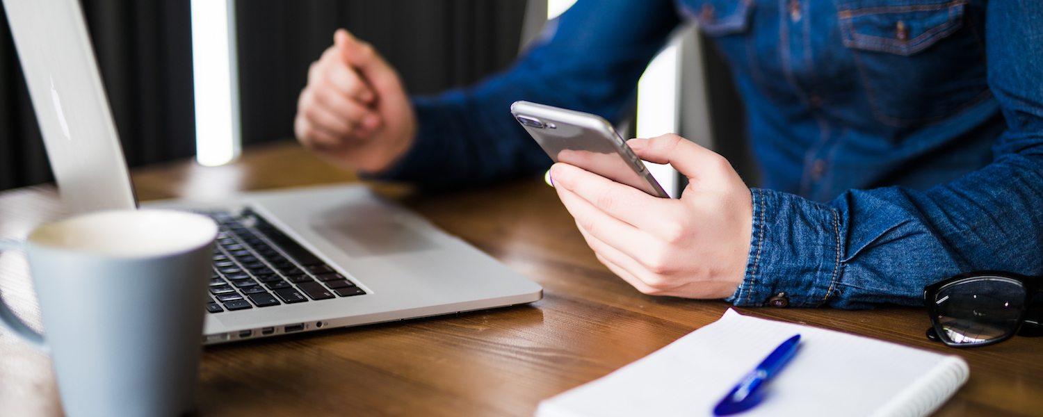 Man with cell phone and laptop - free WiFi amenity